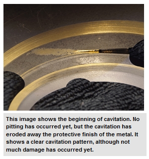 This image shows the beginning of cavitation. No pitting has occurred yet, but the cavitation has eroded away the protective finish of the metal. It shows a clear cavitation pattern, although not much damage has occurred yet.